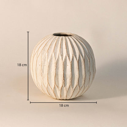 Round carved vase measuring 18 cm in height and 18 cm in width - perfect for tabletop floral arrangements.
