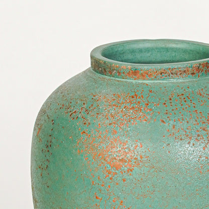 Closeup image of green ceramic textured vase for modern console table decor styling with artistic matte finish.