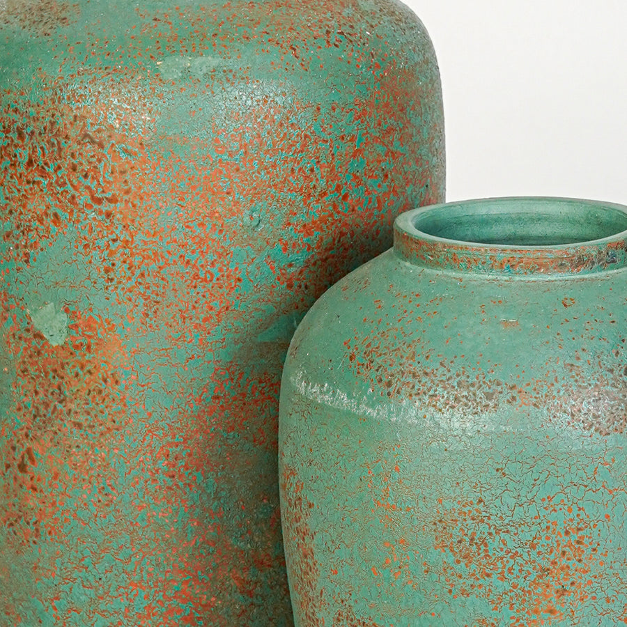 Closeup image of green ceramic textured vase set for modern tabletop decor styling with artistic finish.