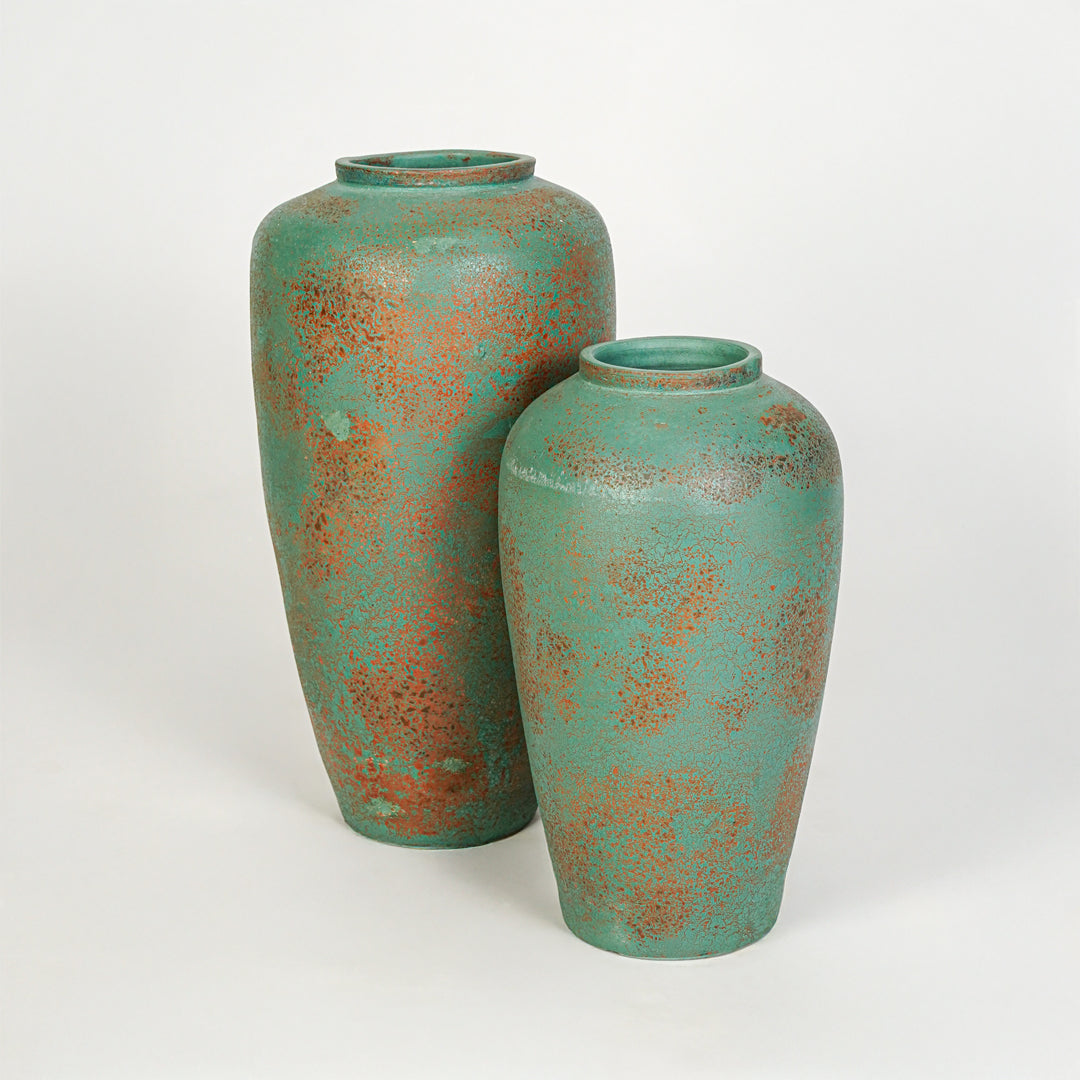 White background image of green ceramic vase set for modern shelf decor styling with textured artistic finish.