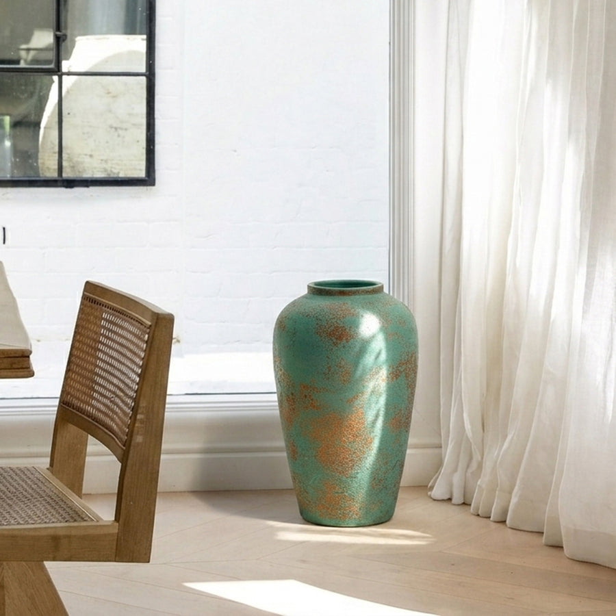 Lifestyle image of green ceramic floor vase for modern living room decor styling with textured artistic finish.