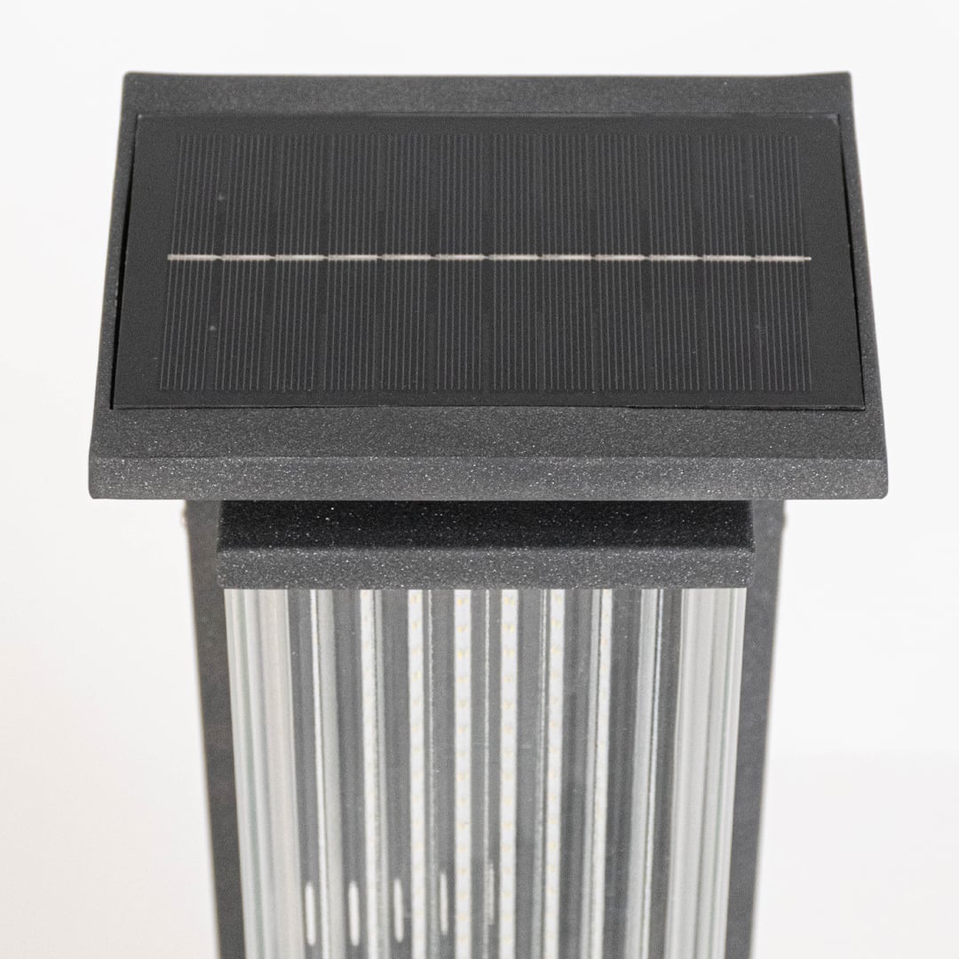 Closeup of solar garden light top displaying rectangular solar panel ribbed diffuser and durable outdoor lighting construction.