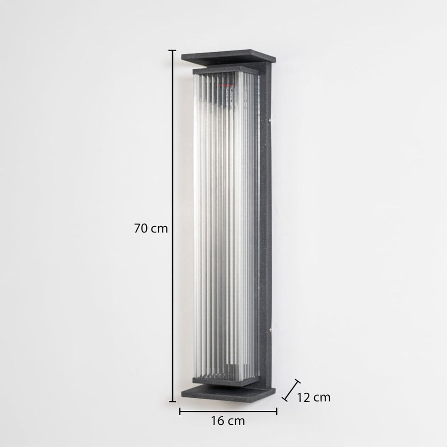 Modern outdoor wall light in black metal with ribbed glass mounted vertically showing 70 cm height 16 cm width and 12 cm projection.