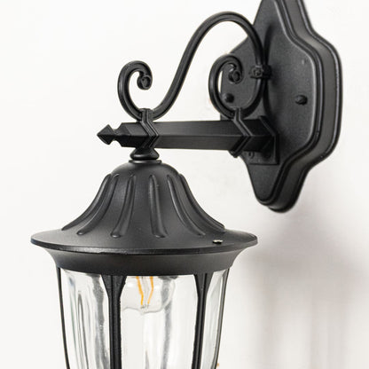 Closeup view of black metal outdoor lantern wall light highlighting clear glass panels sturdy frame and classic exterior lighting design.