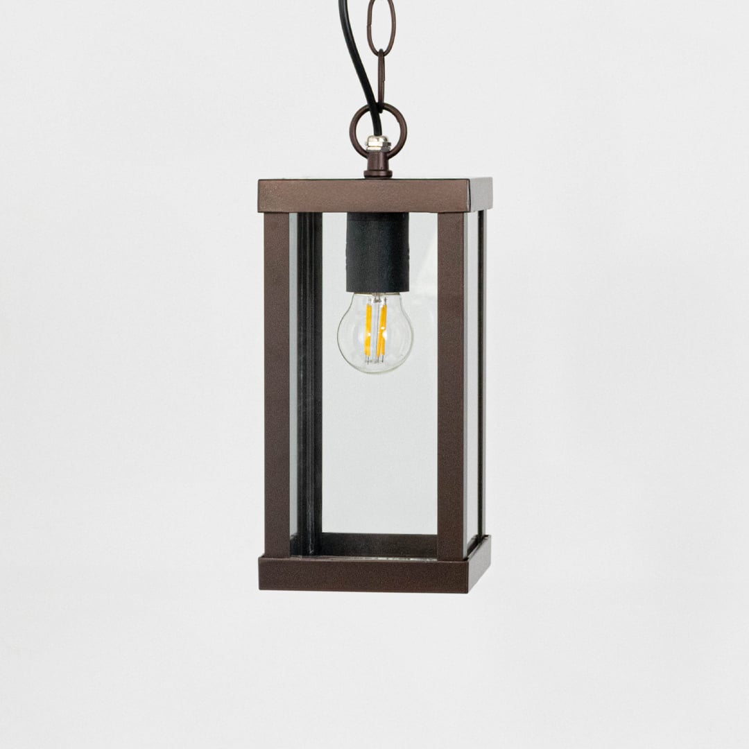 Rectangular outdoor lantern light turned off on white background highlighting clean lines and design.