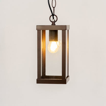 Modern black metal box hanging lantern light with warm glow for stylish outdoor ceiling decor.
