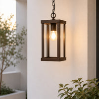 Modern black metal and glass outdoor hanging light for porch entrance balcony and covered patio with warm lighting.