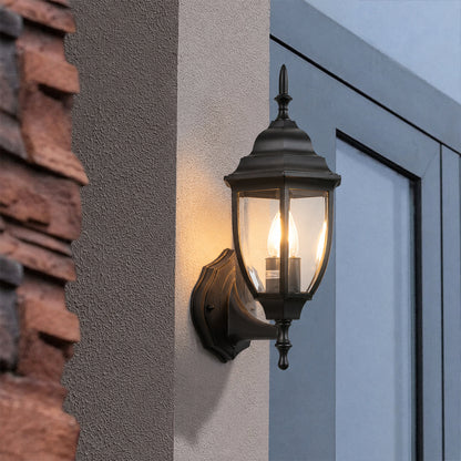 Black metal outdoor wall light lifestyle image beside modern doorway for elegant exterior lighting decor.