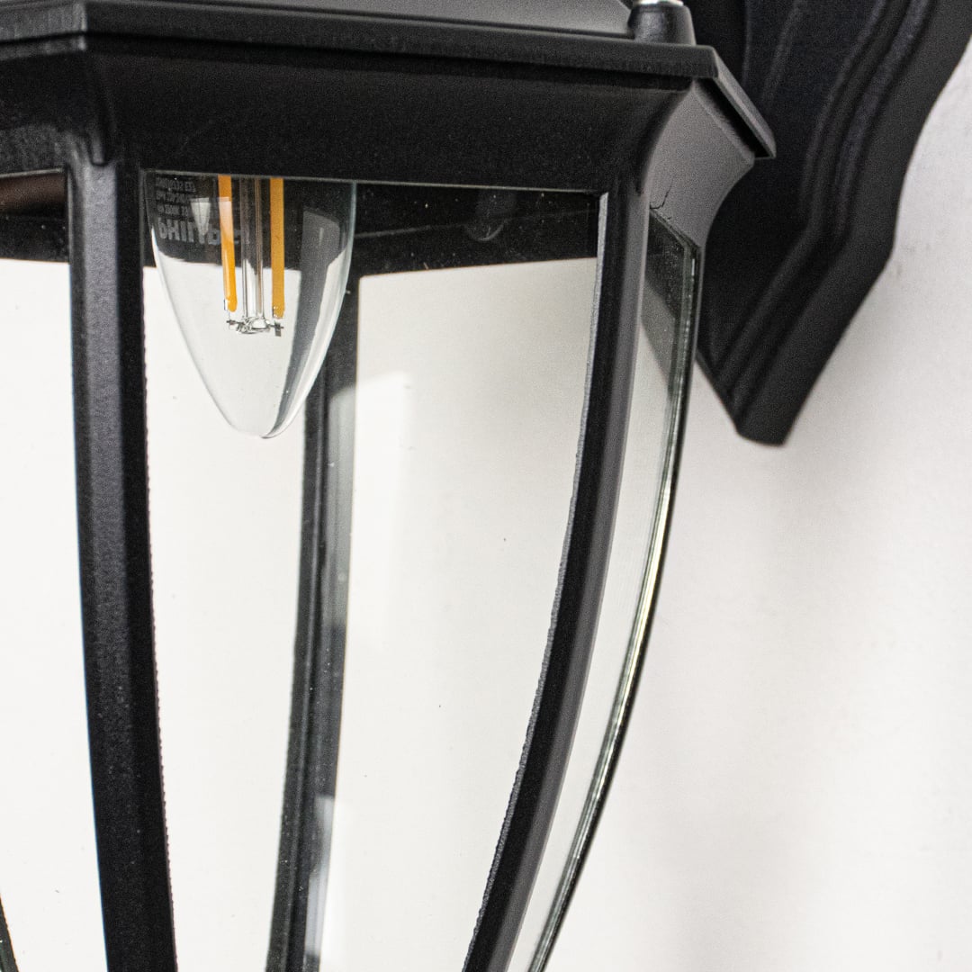 Closeup of large Oxford outdoor wall lantern crafted in black metal with glass panels showcasing bold structure for exterior wall lighting.