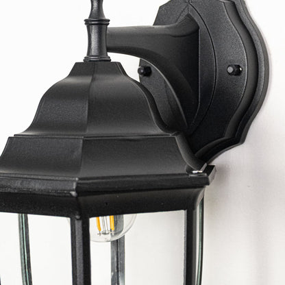 Closeup image of small Oxford outdoor wall lantern in black metal showing refined edges glass enclosure and compact exterior wall styling.