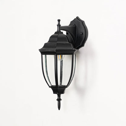 Outdoor wall lantern displayed on white background highlighting black metal frame clear glass panels and classic detailing for clean product visibility.