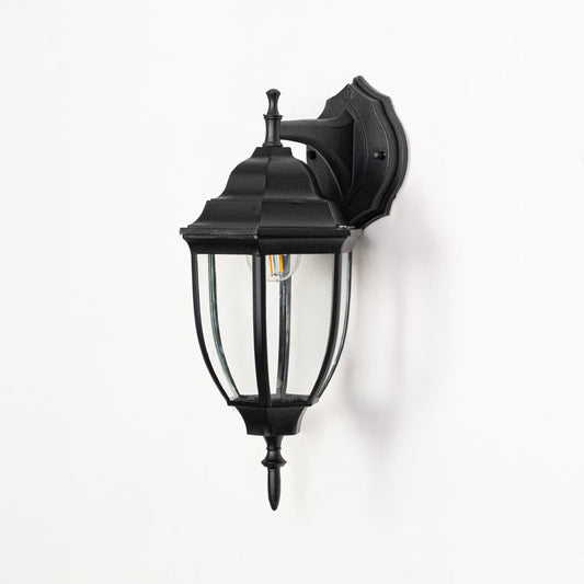 Outdoor wall lantern displayed on white background highlighting black metal frame clear glass panels and classic detailing for clean product visibility.