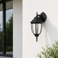 Modern black metal outdoor wall lantern for porch entrance patio and exterior walls with elegant warm ambient lighting.