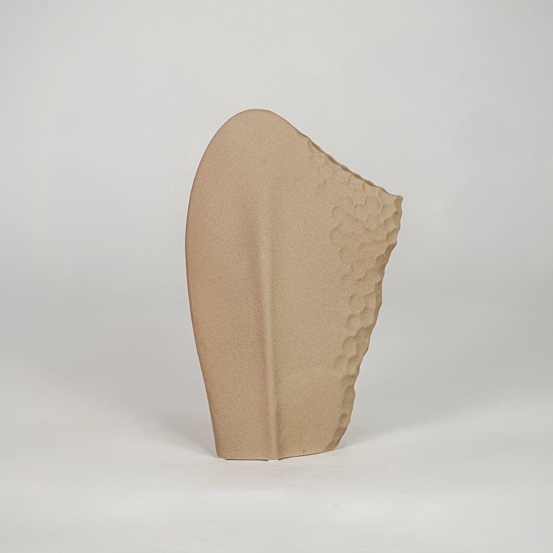 Beige ceramic modern decorative designer vase isolated on clean white background stylish home decor flower vase for shelf table use.