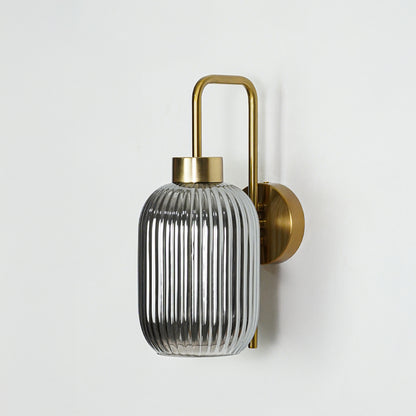 Gold finish wall light with smoked ribbed glass shade perfect for elegant interior wall decor styling on clean background.
