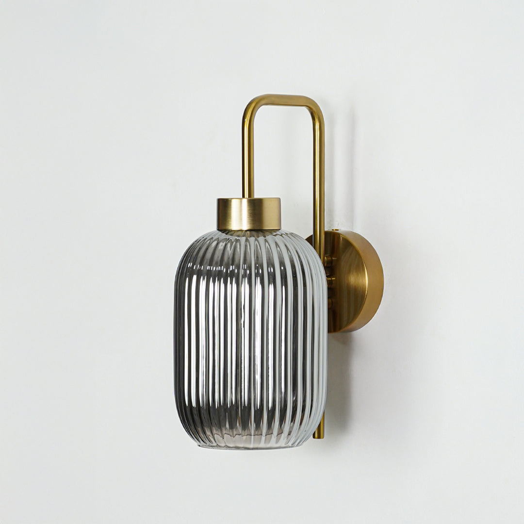Gold finish wall light with smoked ribbed glass shade perfect for elegant interior wall decor styling on clean background.