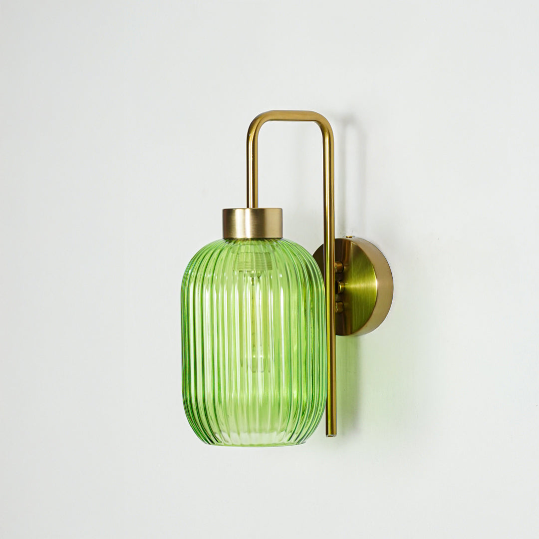Gold metal wall light with green ribbed glass shade and sleek arm design perfect for modern interior wall decor on clean background.