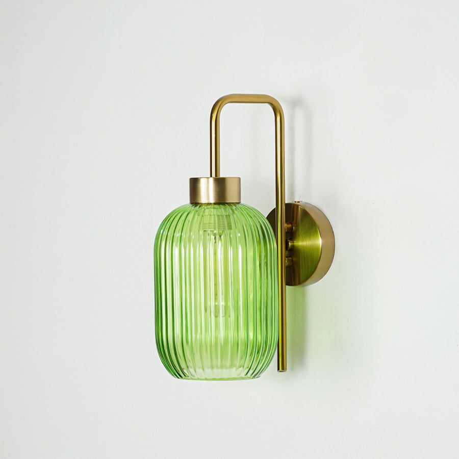 Gold metal wall light with green ribbed glass shade and sleek arm design perfect for modern interior wall decor on clean background.