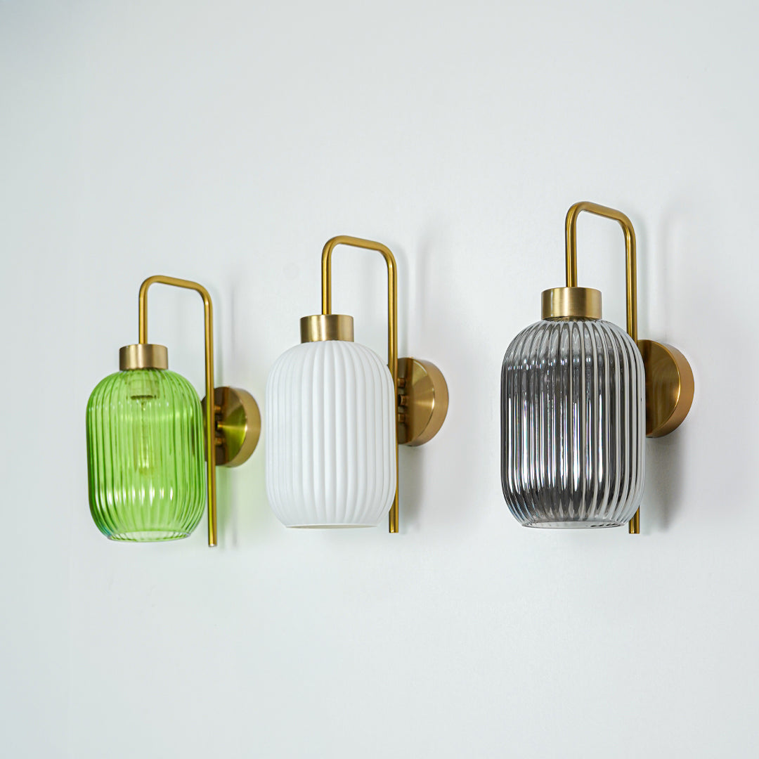 Set of gold metal wall lights with green white and smoked ribbed glass shades ideal for modern bedroom or hallway wall decor.