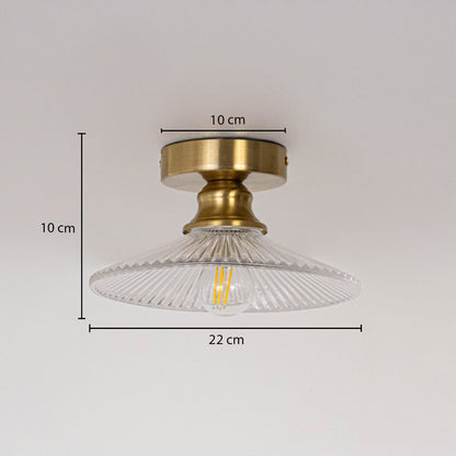 Ceiling light with brushed gold base and clear glass shade shown with size dimensions 10 cm height 22 cm width and 10 cm base.