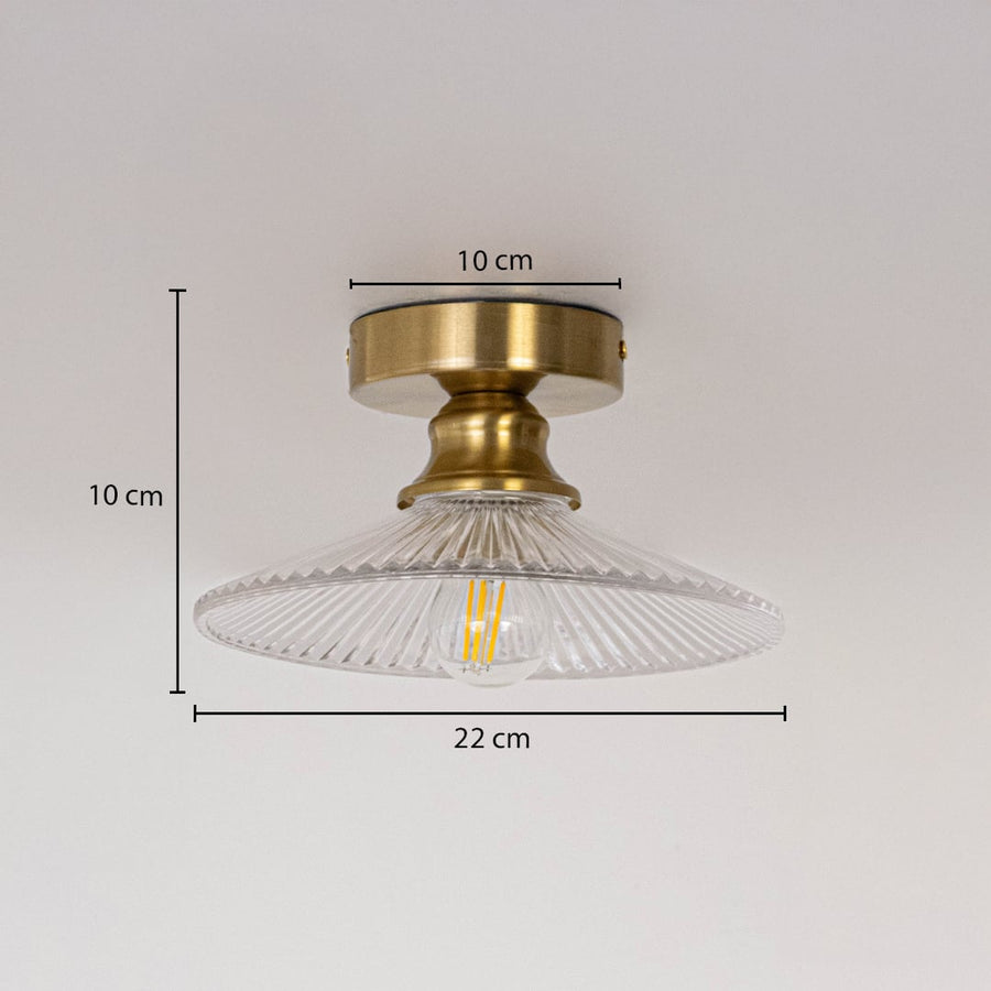 Ceiling light with brushed gold base and clear glass shade shown with size dimensions 10 cm height 22 cm width and 10 cm base.