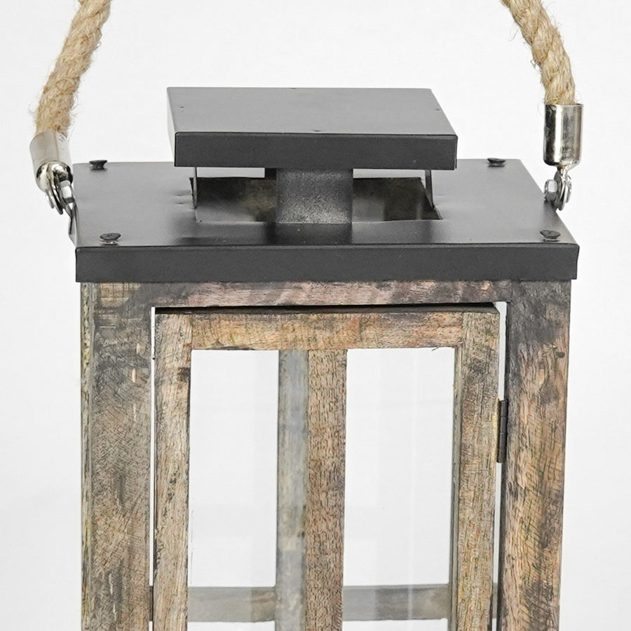 Wooden lantern with metal top on a white background