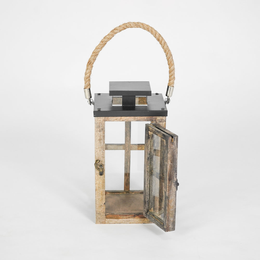 Wooden lantern with a metal top and rope handle on a white background