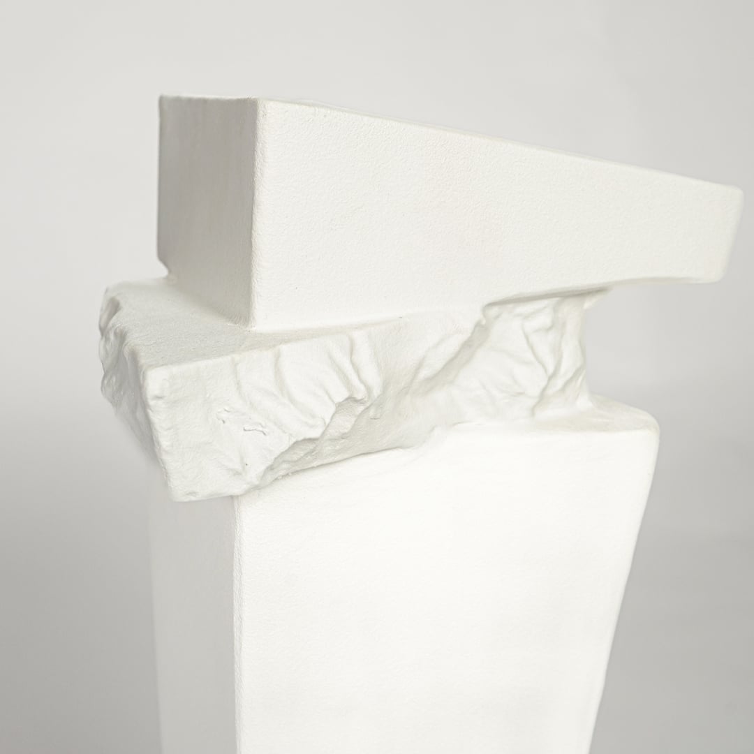 Modern white ceramic statement floor vase with unique geometric form for luxury home interiors.