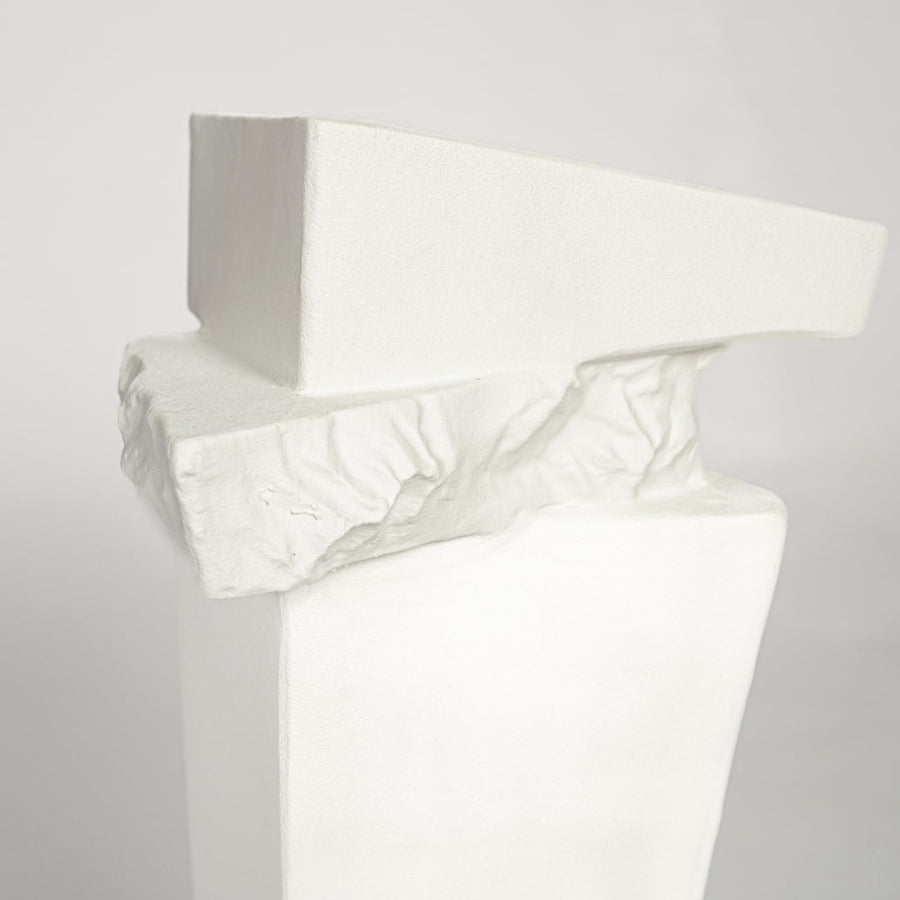 Modern white ceramic statement floor vase with unique geometric form for luxury home interiors.