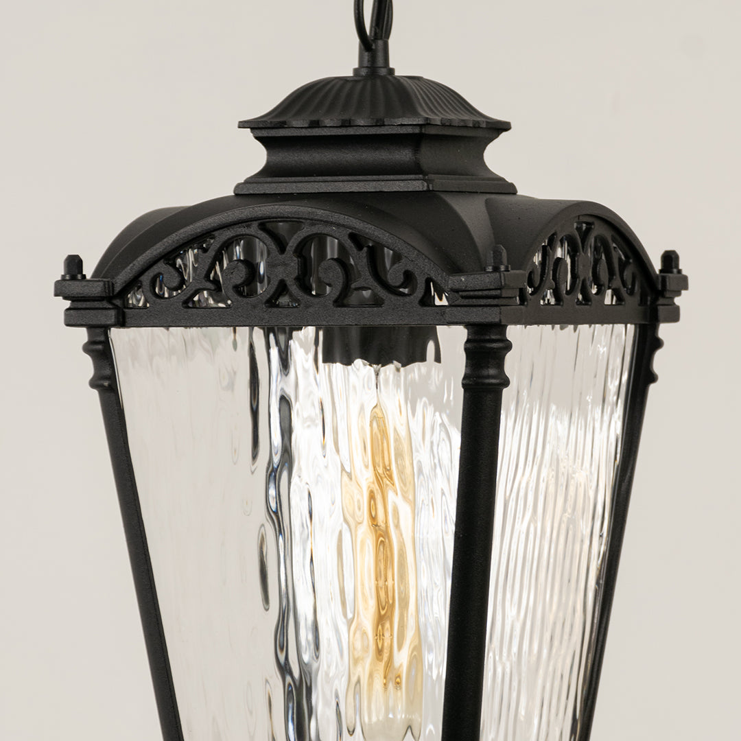 Closeup of black metal outdoor lantern with textured glass panels on white background ideal for gate entrance and exterior decor lighting.