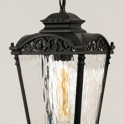Closeup of black metal outdoor lantern with textured glass panels on white background ideal for gate entrance and exterior decor lighting.