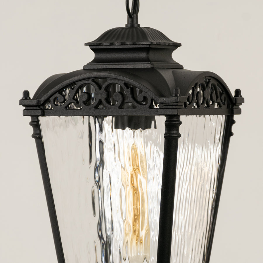 Closeup of black metal outdoor lantern with textured glass panels on white background ideal for gate entrance and exterior decor lighting.