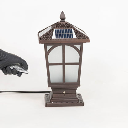 Brown solar pillar light with frosted panels and decorative roof top shown off on clean white surface.