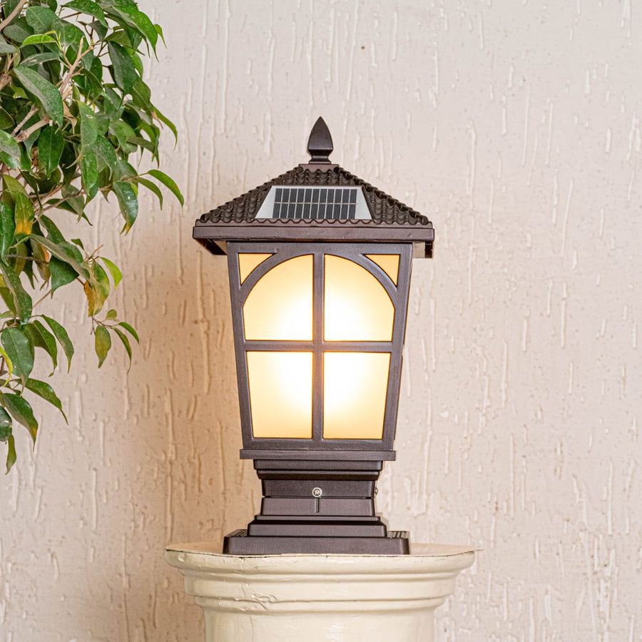 Outdoor solar gate light in black metal with frosted glass displayed on white background highlighting classic exterior lighting design.