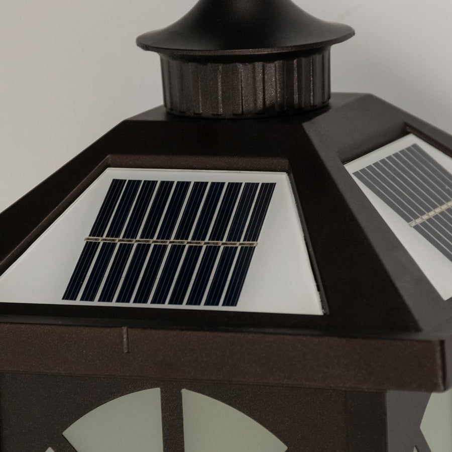 A closeup of the bronze solar lantern showing the frosted panel glow window frame pattern and smooth metal finish highlighting the lantern’s classic outdoor design features.