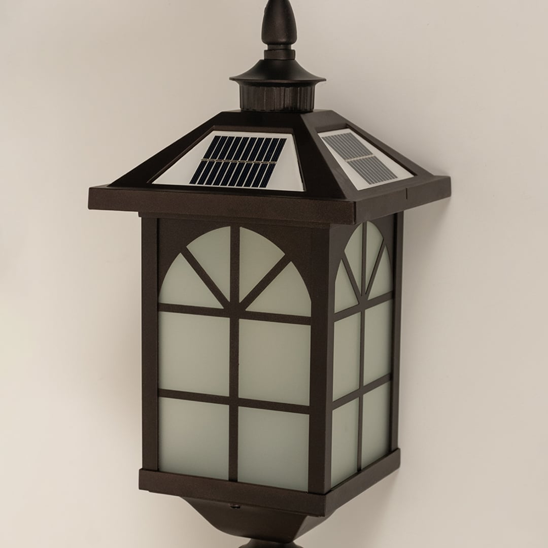 A closeup of the bronze solar lantern showing the frosted panel glow window frame pattern and smooth metal finish highlighting the lantern’s classic outdoor design features.