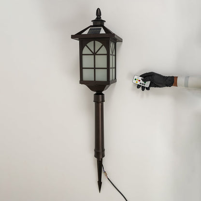 A bronze solar pathway lantern turned off on a white background highlighting the frosted glass panels metal window frame design and long pointed stake for outdoor placement.