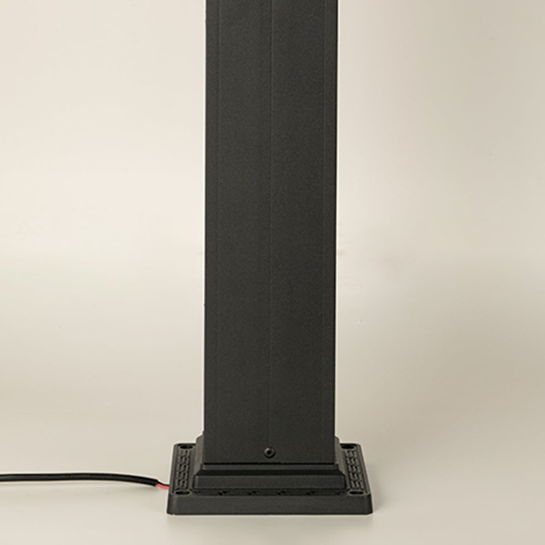 A closeup highlighting the lower section of the outdoor pillar lamp showing the tall rectangular post base plate construction and smooth matte black finish.