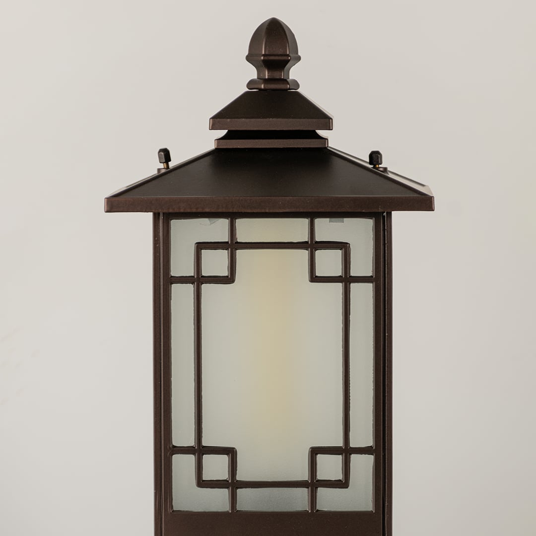 Black outdoor lantern Closeup seeded glass Light On showing the warm ambient glow and decorative pebbled glass panels detail.