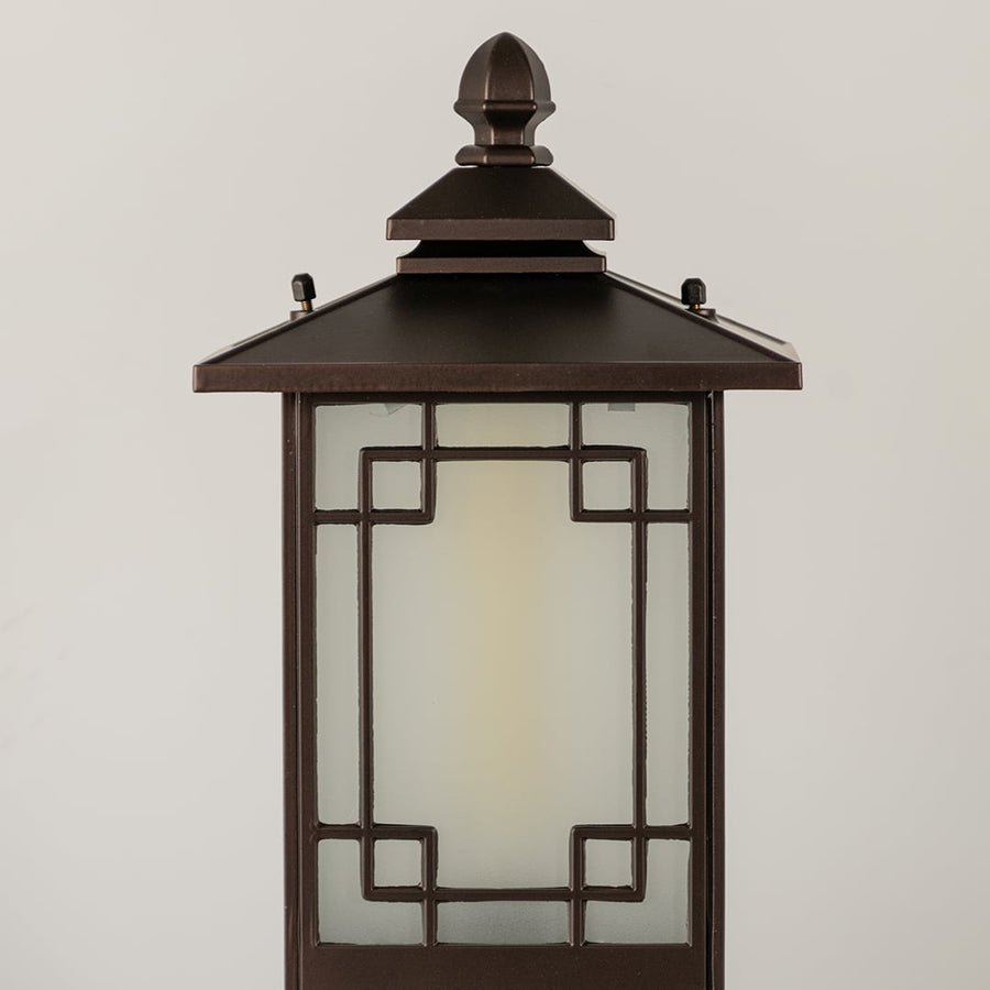Black outdoor lantern Closeup seeded glass Light On showing the warm ambient glow and decorative pebbled glass panels detail.