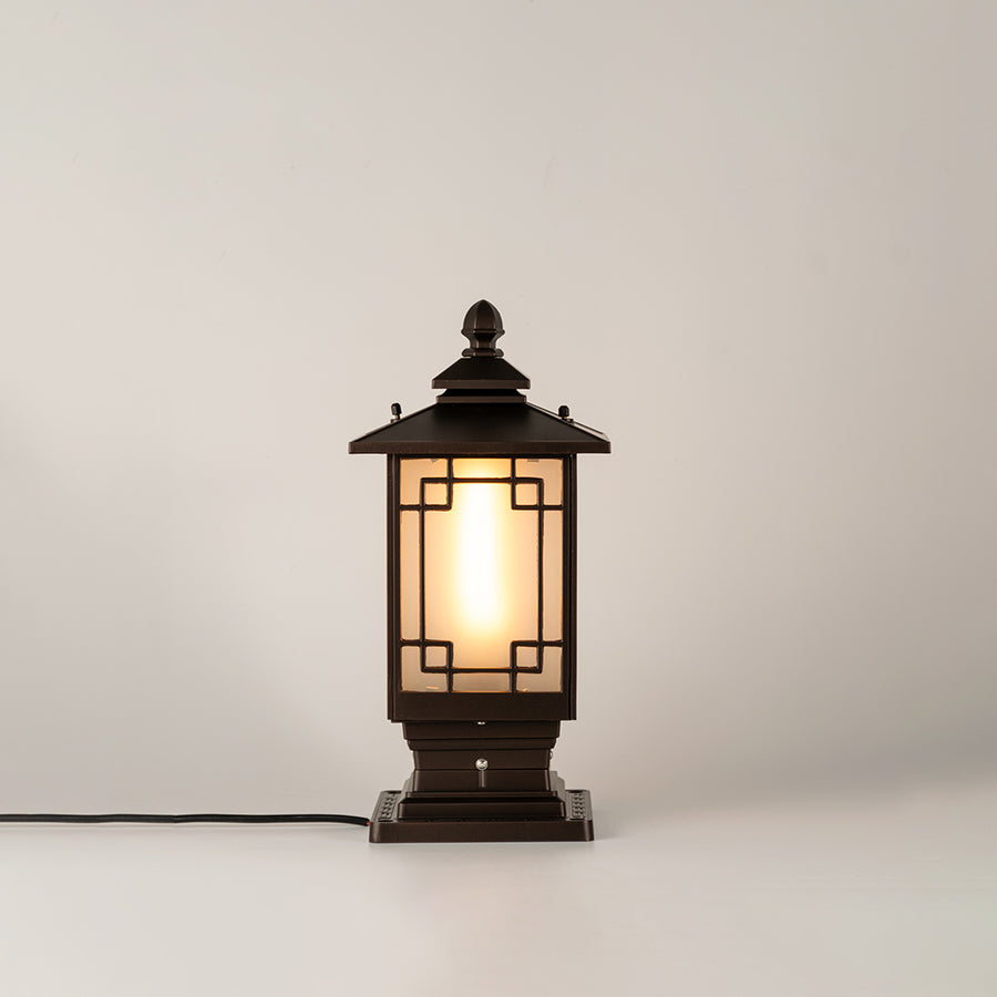 Black outdoor gate light with warm glowing bulb for stylish exterior decor styling use.