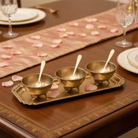 Gold metal condiment bowl set lifestyle image with serving spoons for elegant festive dining table decor.
