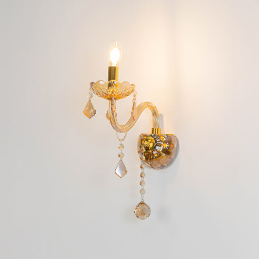 Modern crystal wall light in gold finish with hanging crystals for bedroom or living decor lighting white background.