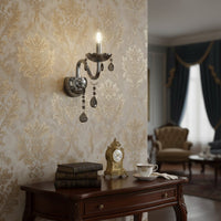 Wall light with chrome metal frame and dark crystal droplets styled on a soft wall background for modern elegant home lighting.