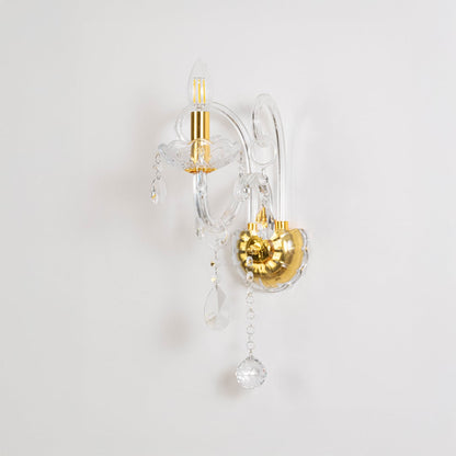 Crystal wall light with golden base and drops elegant wall mounted table lamping on off white background.