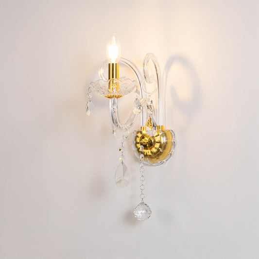 Modern crystal wall light in gold finish with hanging crystals for bedroom or living decor lighting white background.