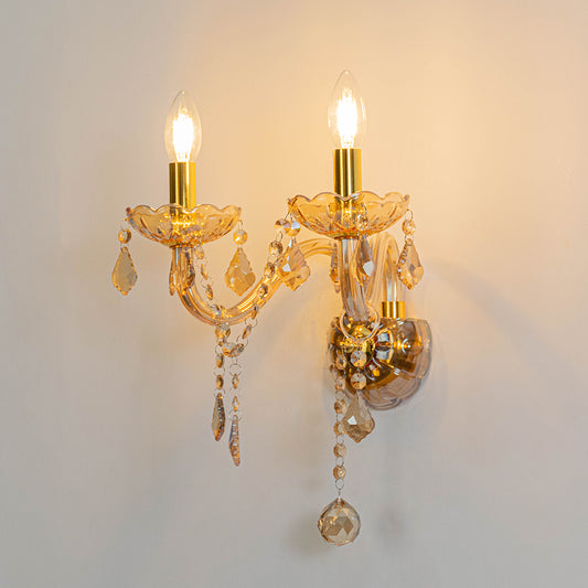 Classic crystal wall light in gold finish with candle bulbs and crystals for living room decor lighting white background.