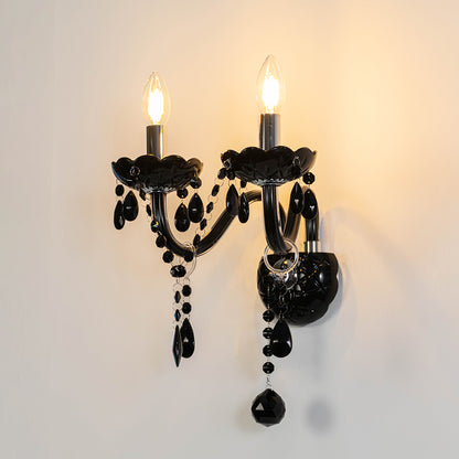 Vintage crystal wall light in black finish with hanging crystals for bedroom or living room decor lighting white background.