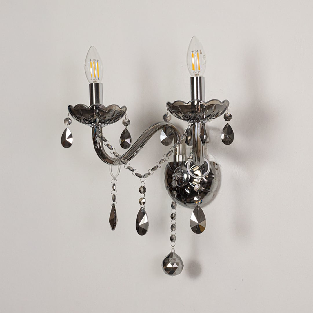 Wall light with chrome metal frame and dark crystal accents displayed on a white background for clear refined product detail.