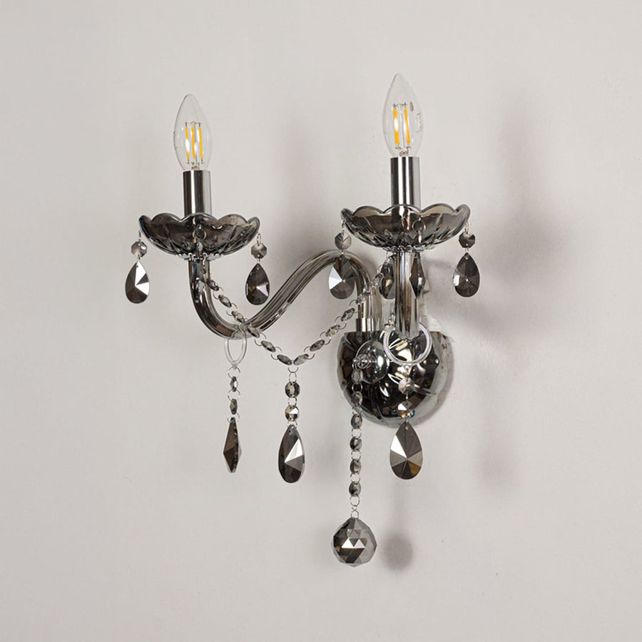 Wall light with chrome metal frame and dark crystal accents displayed on a white background for clear refined product detail.
